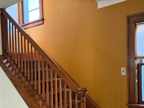 Finished basement hallway painted in a soft neutral color with clean lines and smooth wall finishes