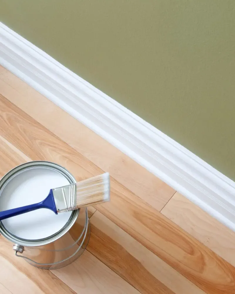 Freshly painted white baseboards and interior trim in a clean home